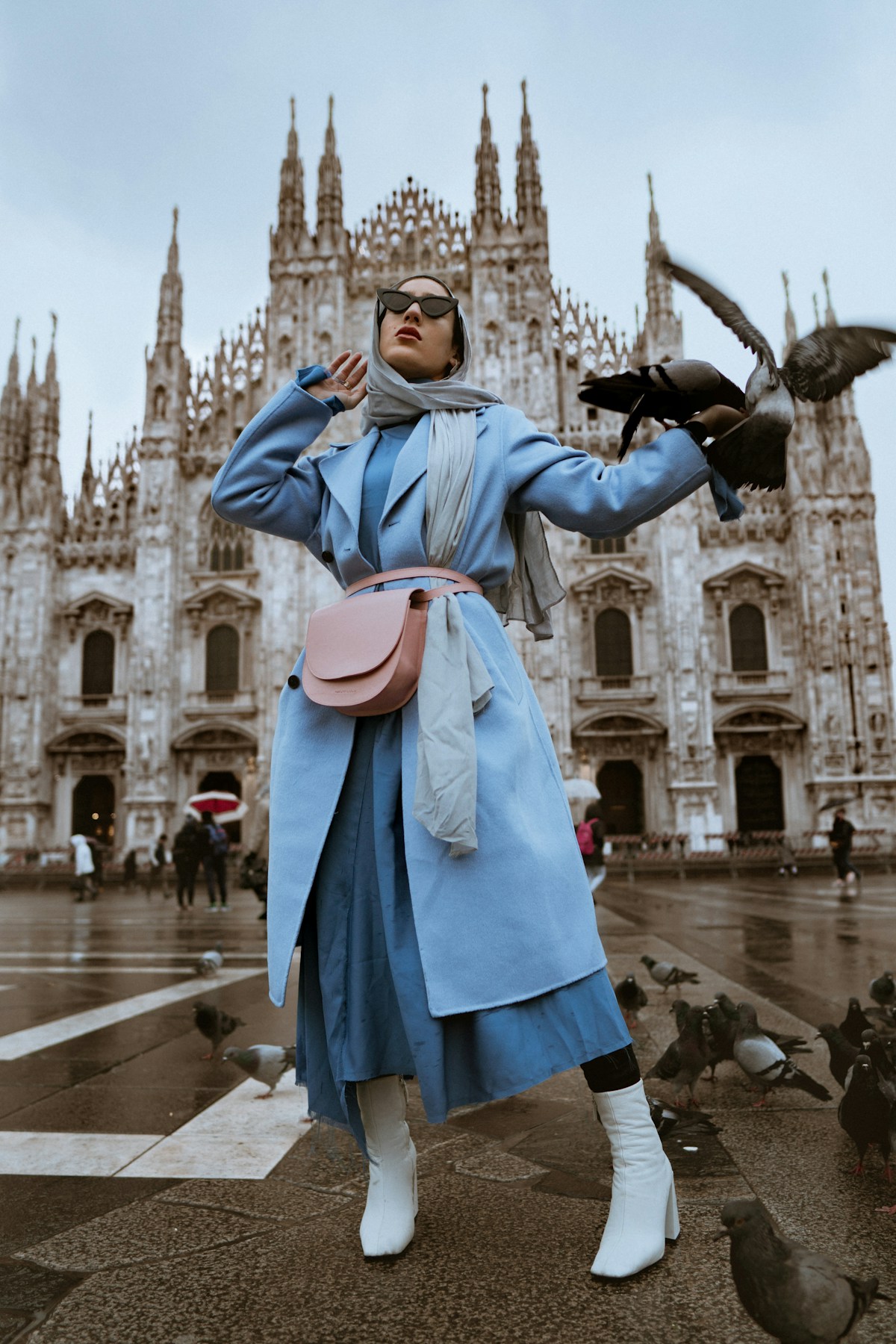 Street-style fashion photograph of a person wearing a blue coat and scarf